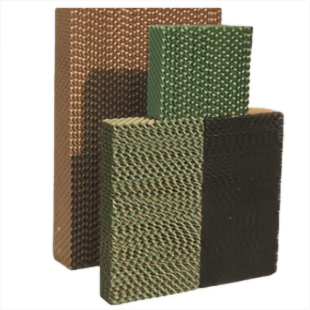Assorted evaporative cooling pads in different colors and honeycomb structures, including brown, green, and black cellulose pads, displayed as product samples